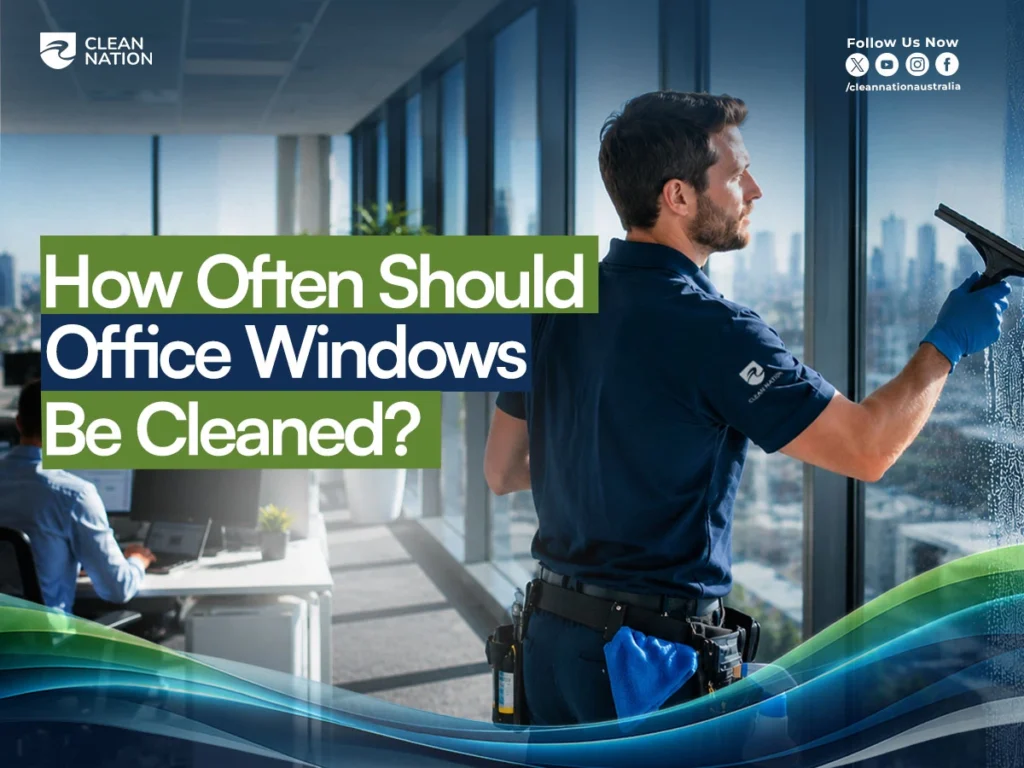 How often should office windows be cleaned? Clean Nation technician performing professional office window cleaning in a modern high-rise workspace.
