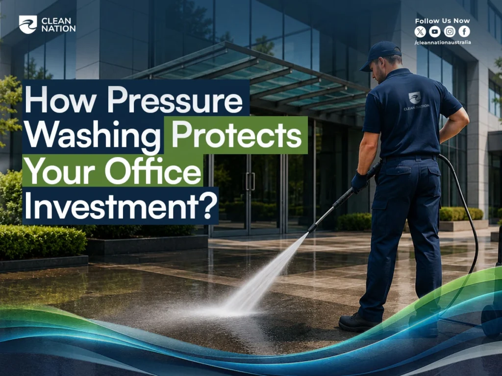 Professional cleaner pressure washing the exterior entrance and pavement of a modern office building, demonstrating How Pressure Washing Protects Your Office Investment by removing dirt, grime, and stains to maintain a clean, professional appearance and preserve property value.