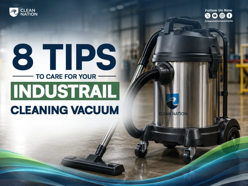Promotional graphic showing a stainless steel industrial cleaning vacuum on a polished factory floor with the headline "8 Tips to Care for Your Industrial Cleaning Vacuum." The Clean Nation branding appears alongside social media icons, highlighting essential maintenance practices for keeping industrial vacuum equipment clean, efficient, and long-lasting.