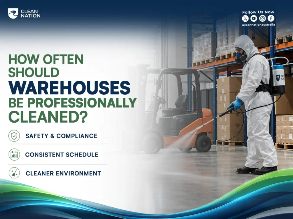 A professional cleaner wearing full protective gear disinfects a warehouse floor beside a forklift and storage racks filled with palletised boxes, illustrating How Often Should Warehouses Be Professionally Cleaned? for maintaining safety, compliance, a consistent cleaning schedule, and a cleaner warehouse environment.