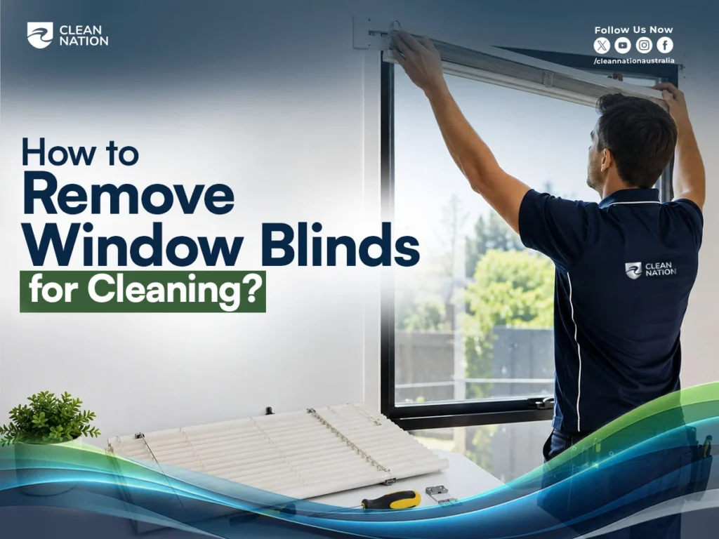 Professional cleaner removing a roller window blind from its mounting bracket before washing, demonstrating How to Remove Window Blinds for Cleaning? in a bright, modern home with cleaning tools placed nearby.