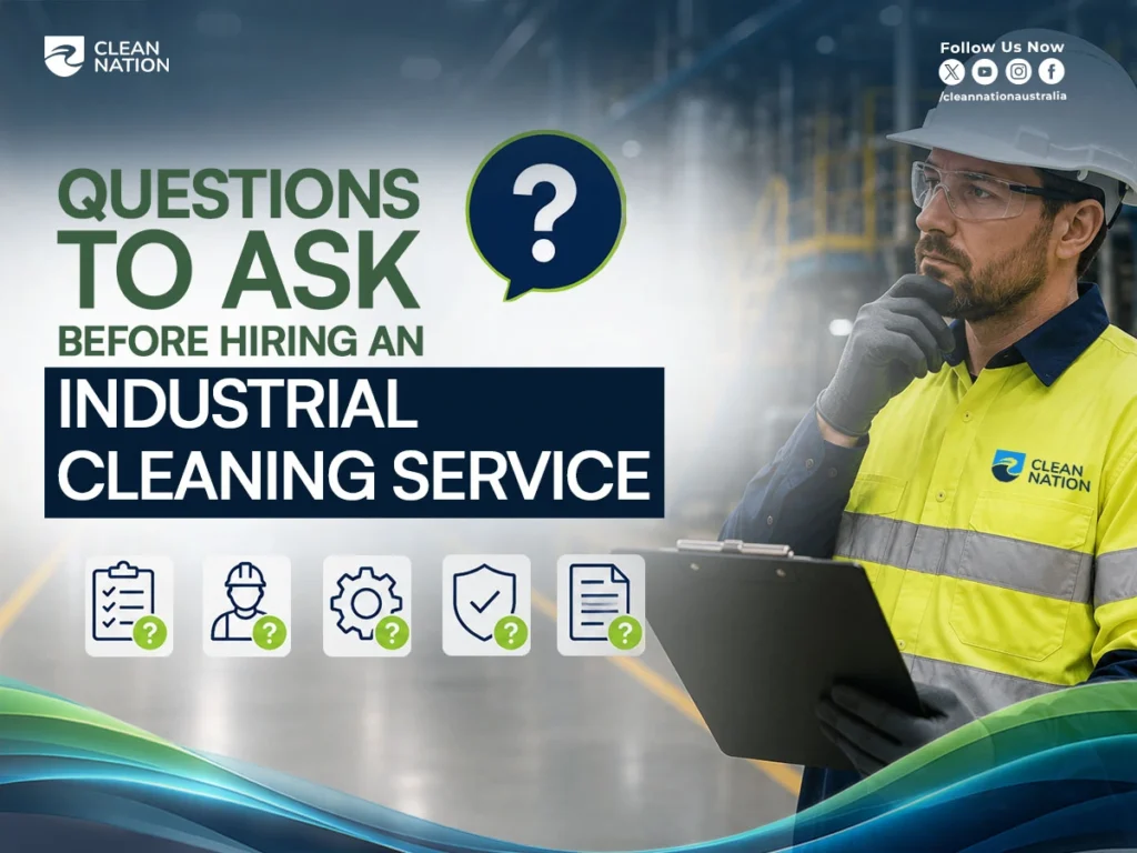 A Clean Nation industrial cleaning professional wearing safety gear reviews a checklist inside a factory, illustrating How to Choose an Industrial Cleaning Service? by highlighting the important questions to ask before hiring an experienced industrial cleaning provider.