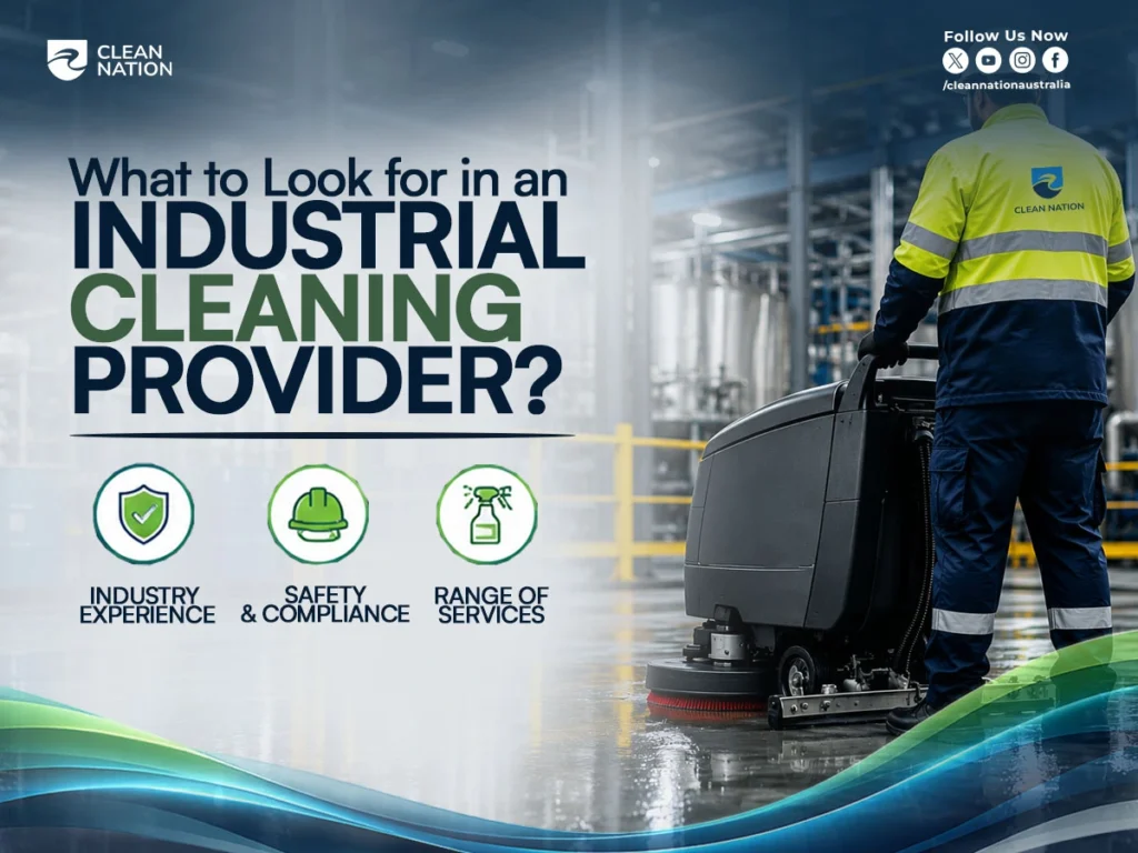 A Clean Nation professional operates an industrial floor scrubber inside a manufacturing facility, highlighting key factors in How to Choose an Industrial Cleaning Service?, including industry experience, safety compliance, and a wide range of cleaning services.