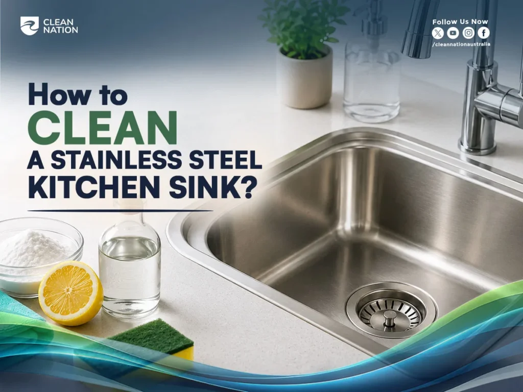 How to Clean a Stainless Steel Kitchen Sink? A clean stainless steel kitchen sink with a sponge, lemon, baking soda, and water on the countertop, illustrating simple sink cleaning methods.