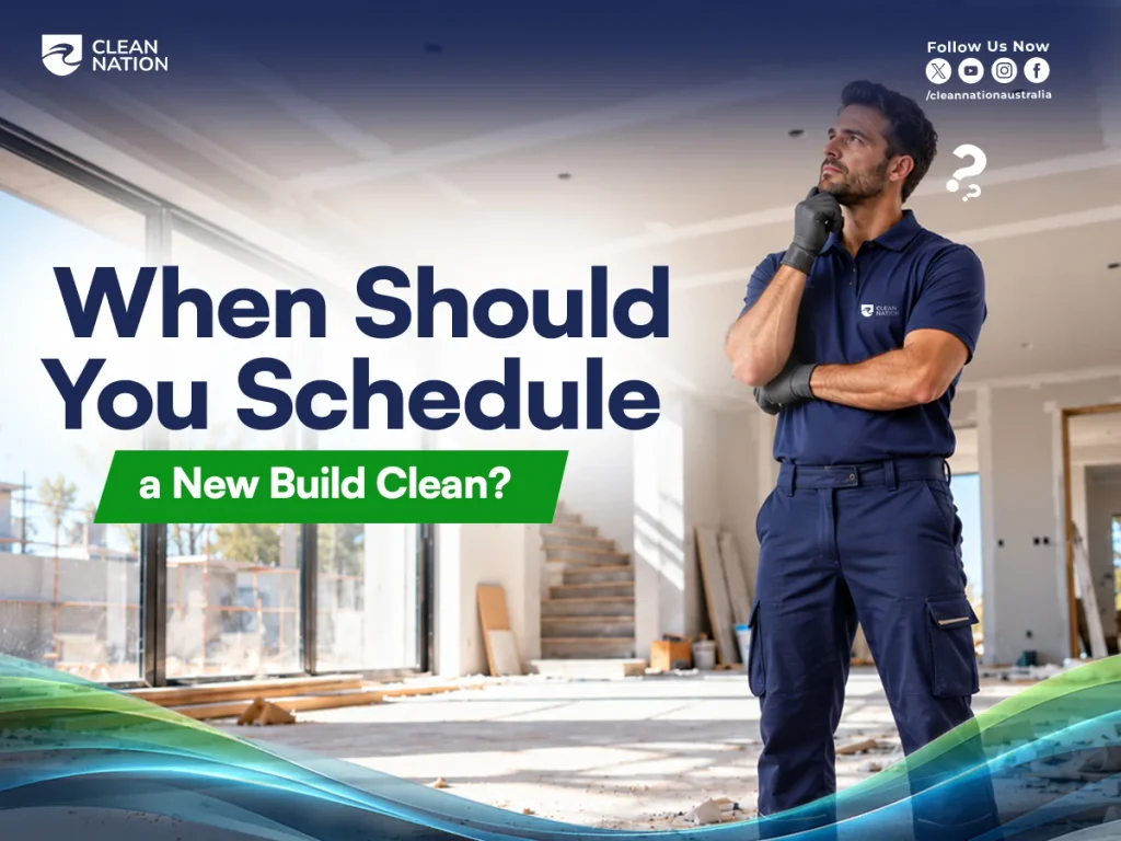 Professional cleaner in navy uniform considering when to schedule a new build clean inside a newly constructed house.