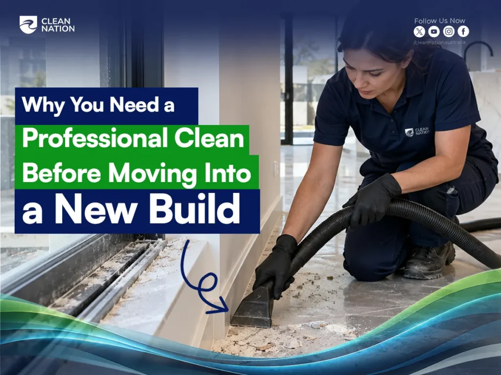 Professional cleaner using a vacuum to remove construction dust and debris along the floor edges of a newly built home before move-in.