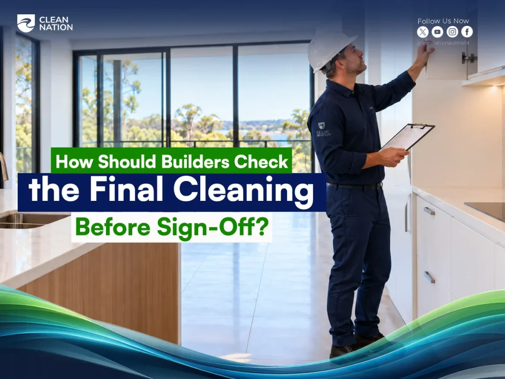 Builder in a hard hat with a clipboard inspecting kitchen cabinetry as part of the final cleaning check before sign-off